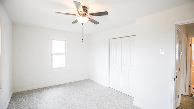 unfurnished bedroom with carpet flooring, a closet, and ceiling fan