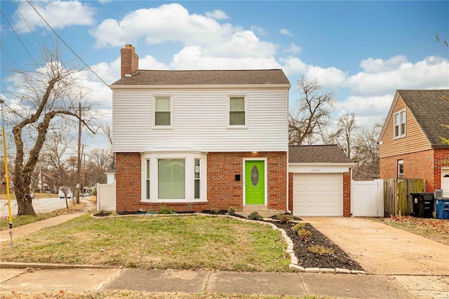 front of property with a front lawn and a garage