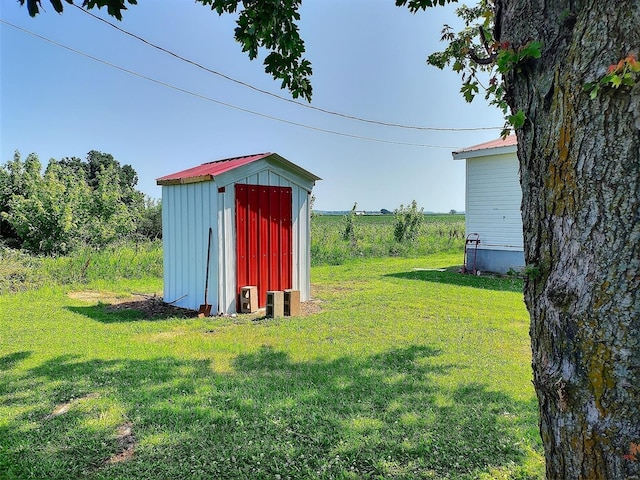 view of outbuilding with a yard