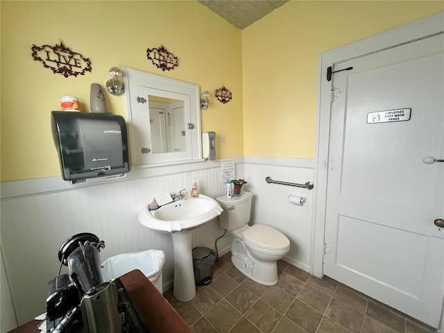 bathroom featuring tile patterned flooring, sink, and toilet