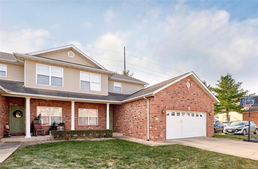 front facade with a front yard and a garage