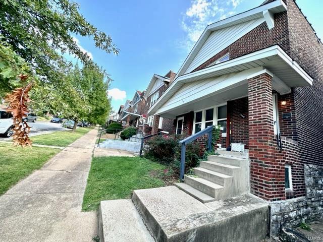 view of side of home with covered porch