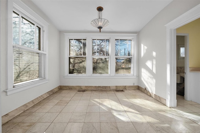 unfurnished dining area featuring light tile patterned flooring