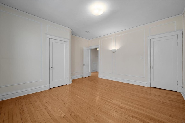 empty room with light hardwood / wood-style floors