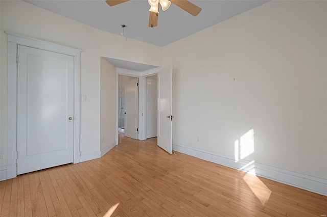 unfurnished bedroom with ceiling fan and light hardwood / wood-style flooring