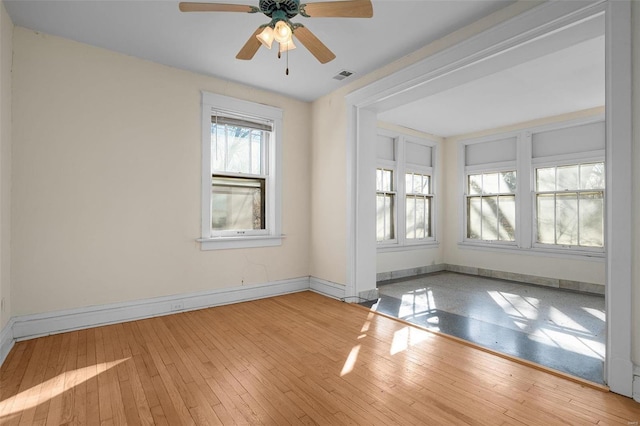 spare room featuring hardwood / wood-style flooring and ceiling fan