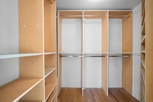 walk in closet with hardwood / wood-style floors