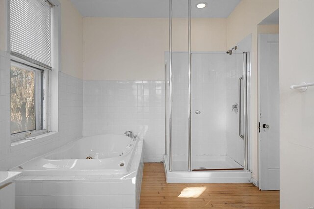 bathroom with wood-type flooring and plus walk in shower