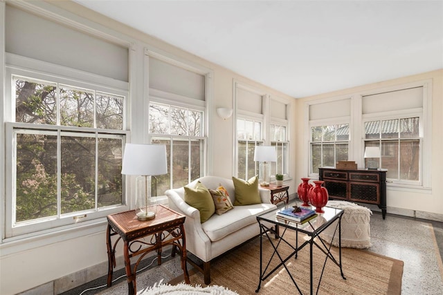 sunroom / solarium with baseboards and speckled floor