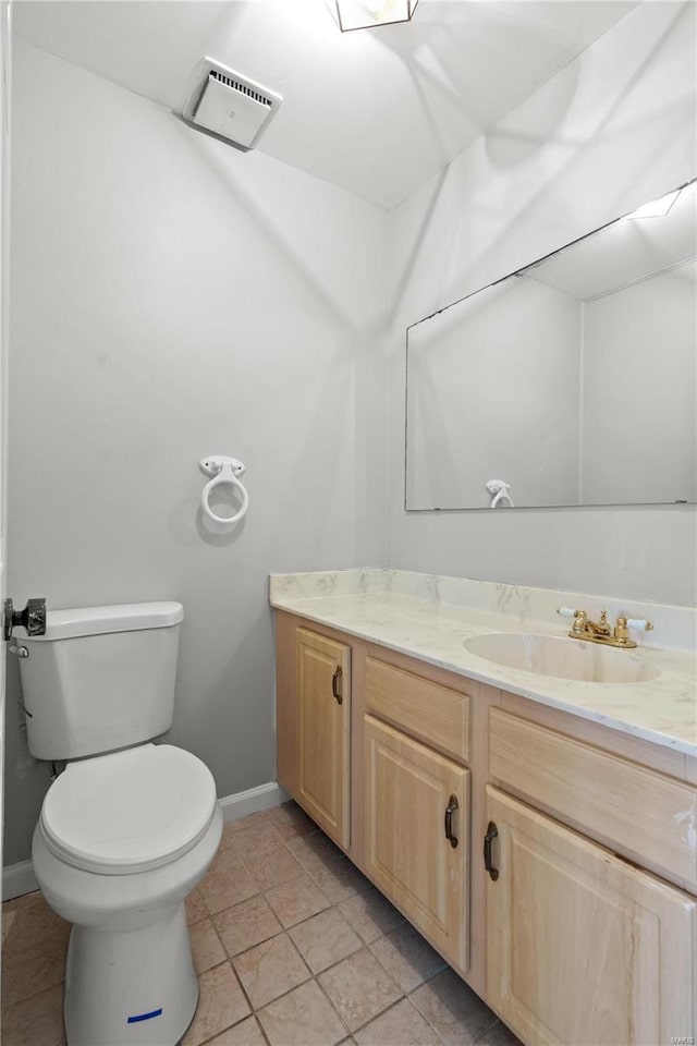 bathroom featuring tile patterned flooring, vanity, and toilet