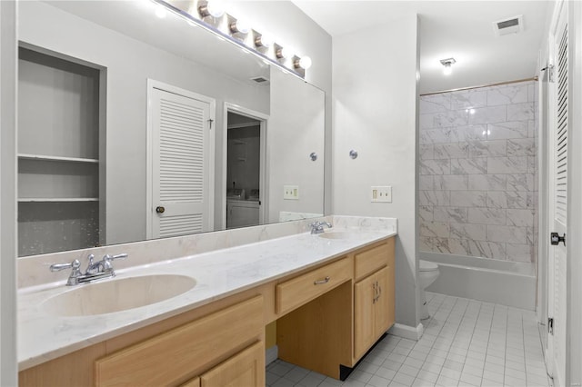 full bathroom featuring toilet, vanity, tile patterned floors, and tiled shower / bath combo