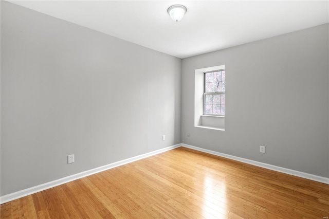 spare room with hardwood / wood-style floors