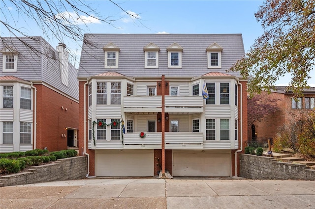 view of front facade with a balcony and a garage