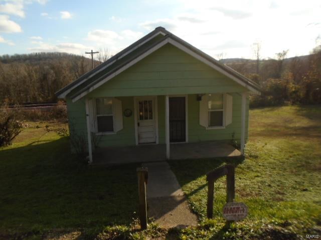 bungalow with a porch and a front yard