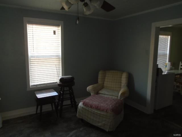 sitting room featuring ceiling fan and ornamental molding