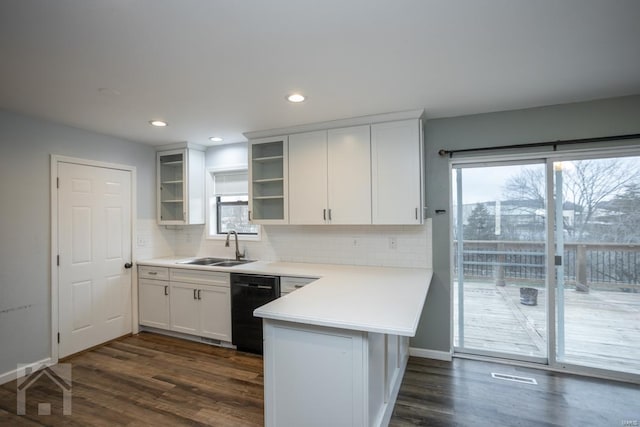 kitchen with sink, dark wood-type flooring, black dishwasher, backsplash, and white cabinets