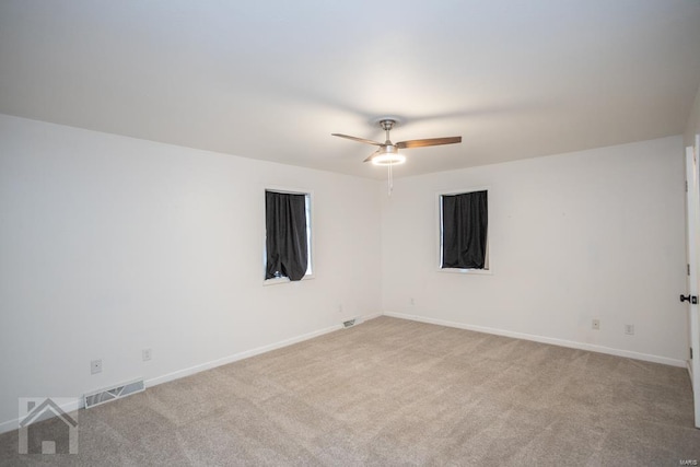 carpeted empty room featuring ceiling fan