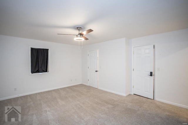 unfurnished room featuring light colored carpet and ceiling fan