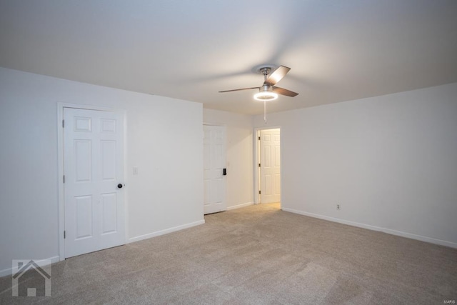 carpeted spare room with ceiling fan