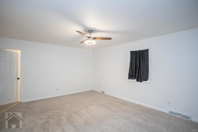 carpeted empty room featuring ceiling fan