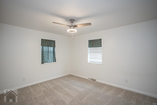 carpeted empty room featuring ceiling fan