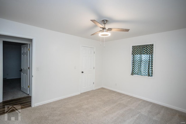 spare room featuring light carpet and ceiling fan