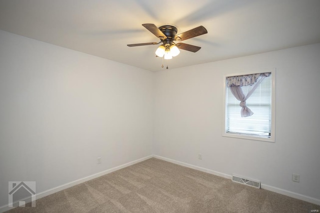 spare room featuring carpet and ceiling fan