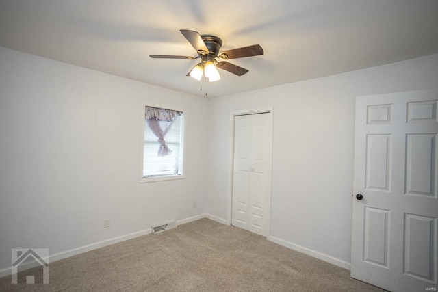 unfurnished bedroom with ceiling fan, a closet, and carpet