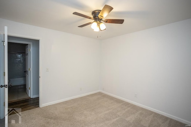 carpeted empty room featuring ceiling fan