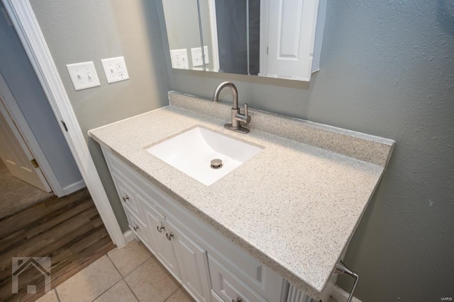 bathroom with tile patterned floors and vanity