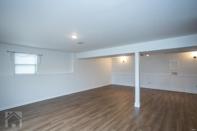 basement with dark hardwood / wood-style flooring