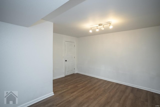 unfurnished room featuring dark wood-type flooring