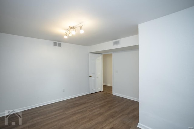 unfurnished room with dark hardwood / wood-style flooring