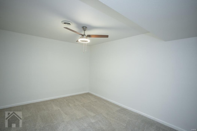 carpeted spare room with ceiling fan