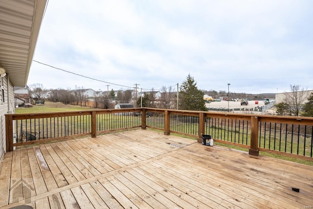 wooden deck with a lawn