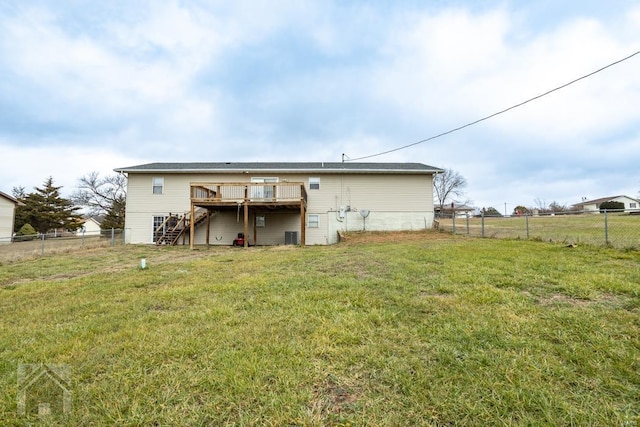 back of property with a lawn, cooling unit, and a wooden deck