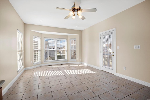 unfurnished room featuring light tile patterned floors and ceiling fan