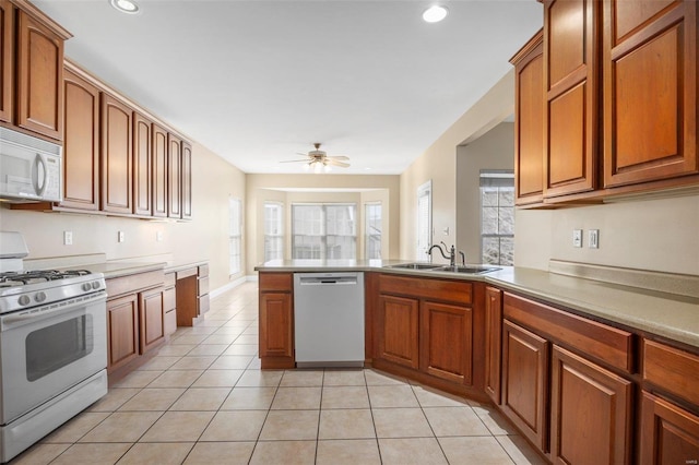 kitchen with ceiling fan, light tile patterned flooring, white appliances, and sink