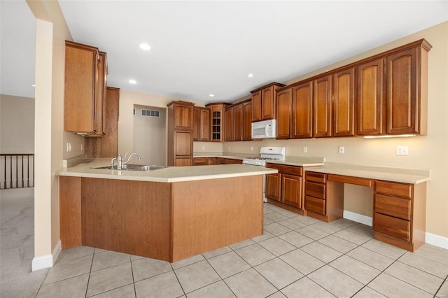 kitchen with kitchen peninsula, sink, light tile patterned flooring, and white appliances