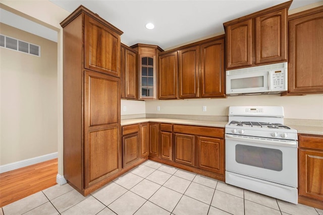 kitchen featuring light wood-type flooring and white appliances