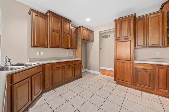 kitchen featuring light tile patterned floors and sink