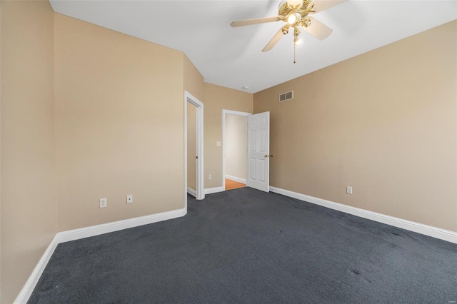 unfurnished room with ceiling fan and dark colored carpet