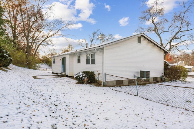 snow covered property featuring central air condition unit