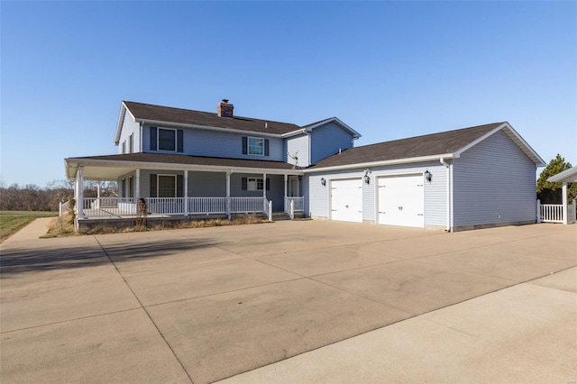 farmhouse featuring covered porch and a garage