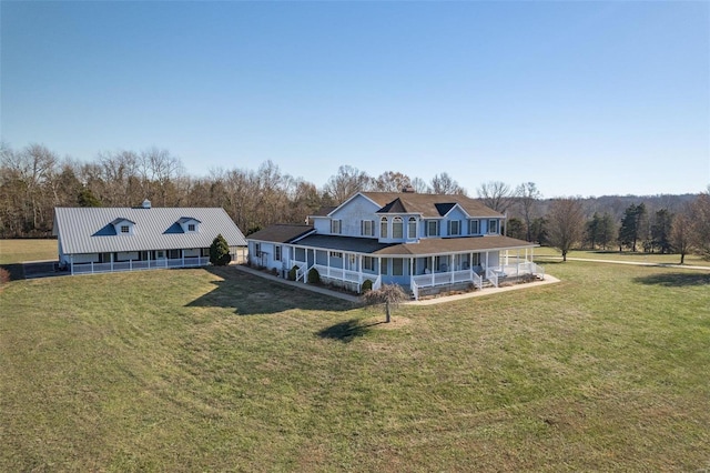 rear view of property featuring a porch and a yard