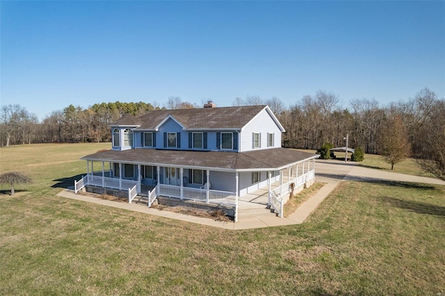 farmhouse inspired home with covered porch and a front yard