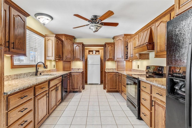 kitchen featuring black appliances, sink, ceiling fan, light tile patterned flooring, and custom range hood