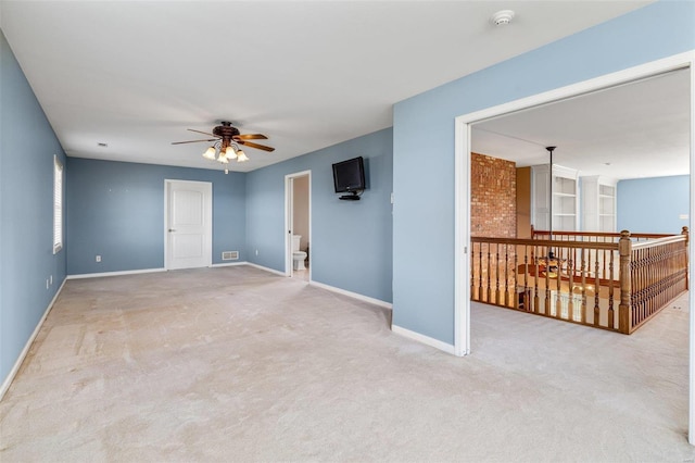 carpeted empty room with ceiling fan