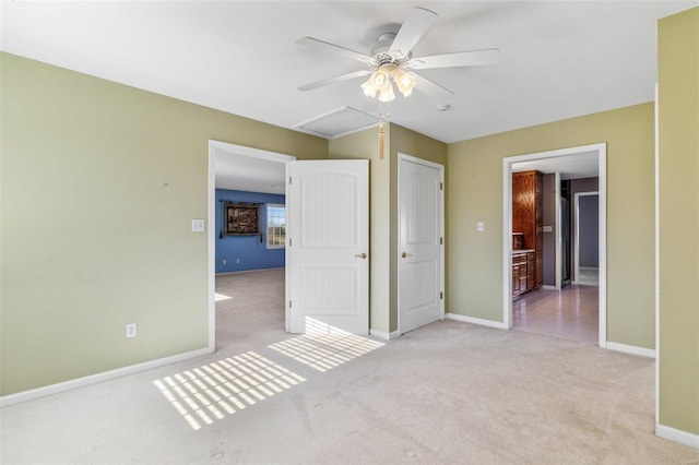 unfurnished bedroom featuring ceiling fan, light colored carpet, and connected bathroom