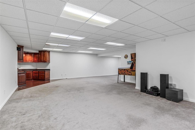 basement featuring carpet and a drop ceiling